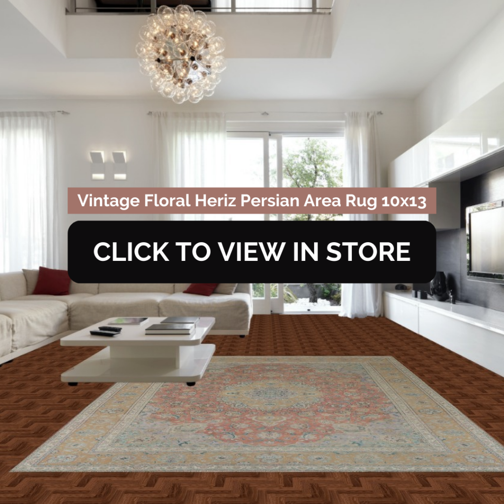 Elegant living room featuring a 10x13 Vintage Floral Heriz Persian area rug with intricate floral motifs in warm red and beige hues. The rug rests on rich parquet wood flooring, complementing a white modern sectional sofa with red throw pillows and a sleek white coffee table. Large windows and contemporary decor complete the sophisticated ambiance.